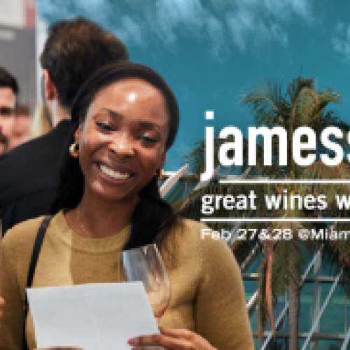 Two people enjoying wine at a promotional event for "jamessuckling great wines world" in Miami, 2025, at the Miami Beach Convention Center.